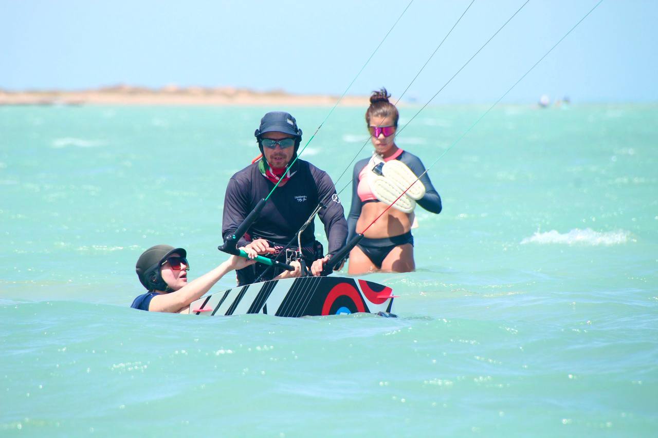 Kite instructor explains to a student how to do a waterstart